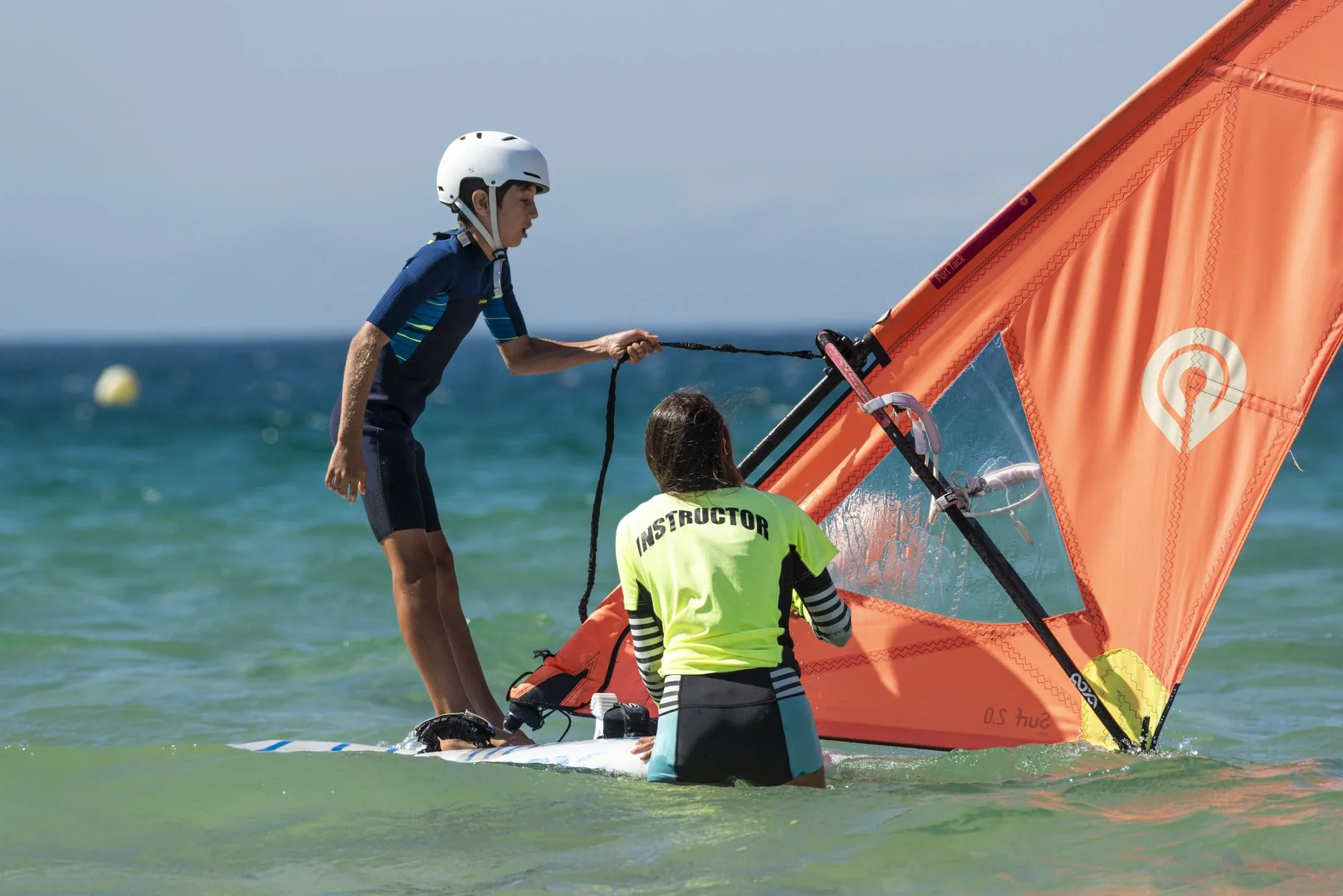 Windsurfing discovery lesson Koh Samui — beginner sail rigging on flat water lagoon