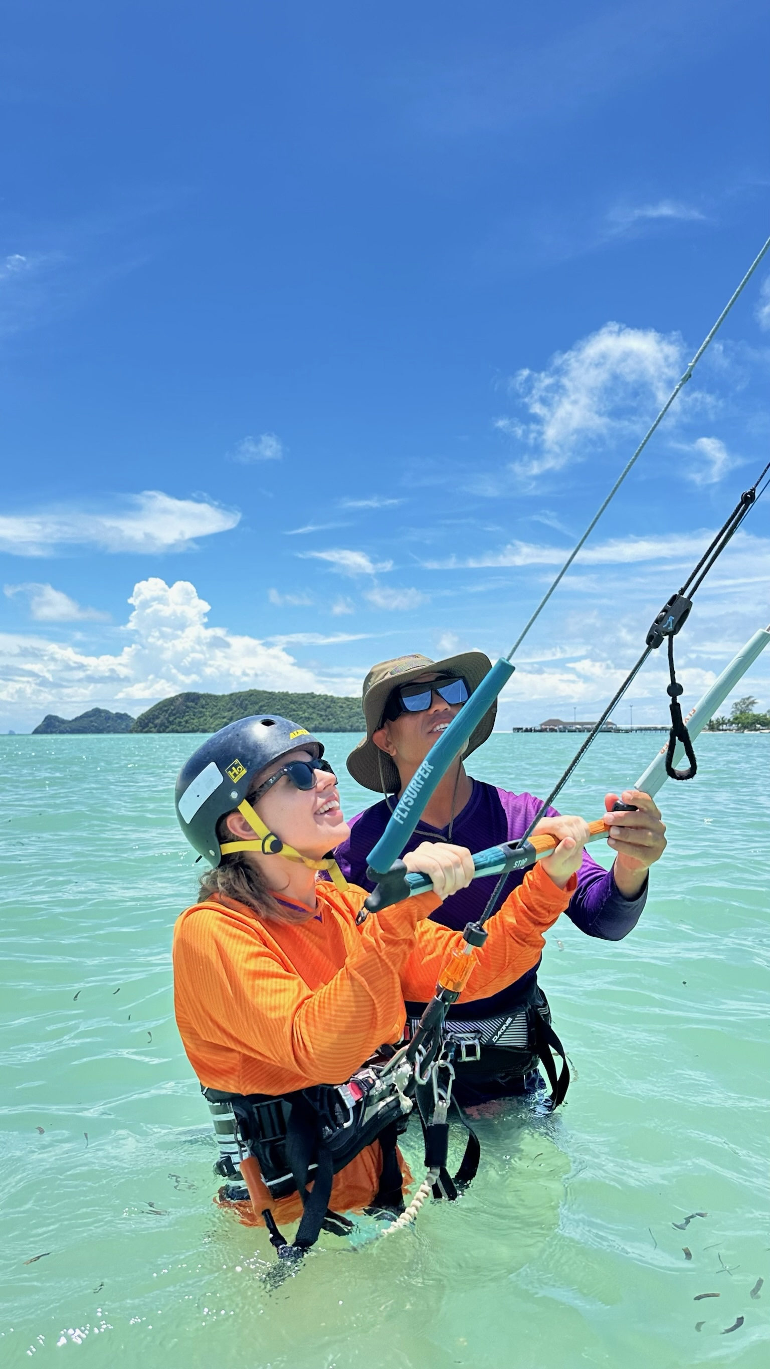 IKO kitesurfing lesson with radio helmet coaching at Koh Samui — instructor and student on flat water lagoon