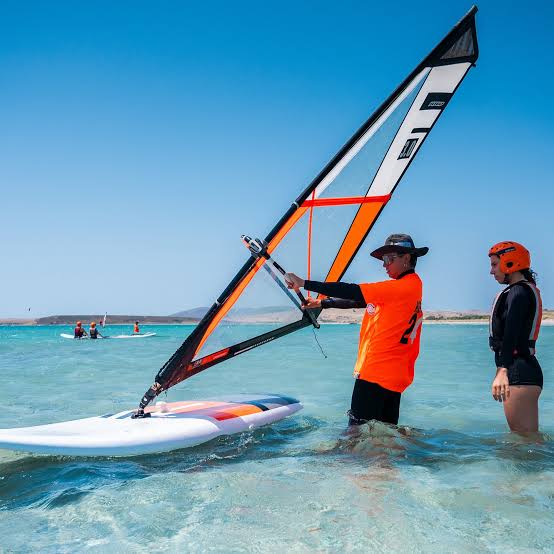 Learn to windsurf at Koh Samui — windsurfing instructor coaching on flat water lagoon